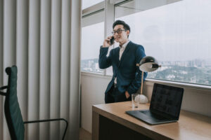businessman on phone in high rise office